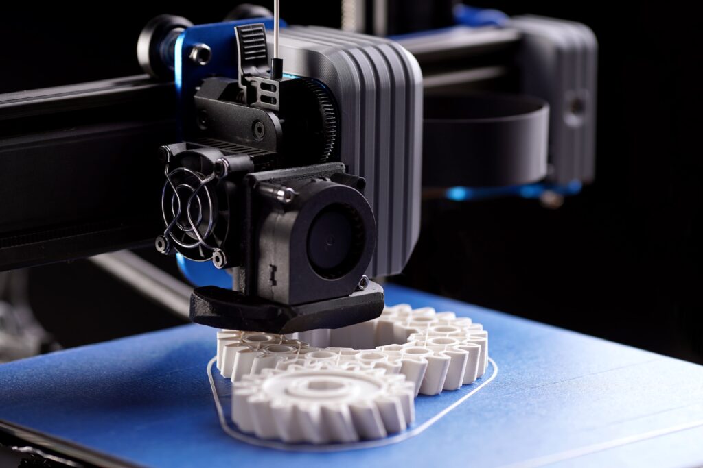 3D tiskanje iz belega filamenta na modri podlagi